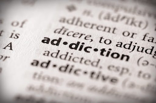 An image of a dictionary showing the addiction word.