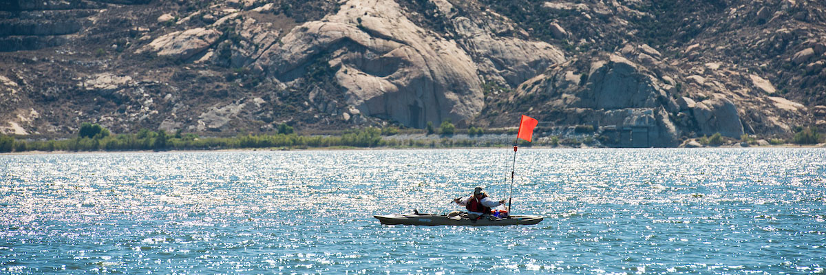 A kayaker fishes from her kayak at Lake Perris on October 2, 2014.